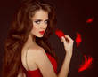 Woman with beauty long curly brown hair and red lips. Fashion wo 