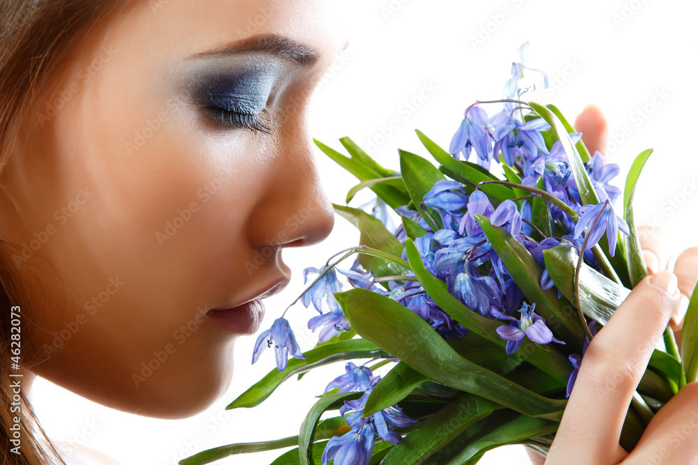 Beautiful teen girl smell and enjoy fragrance of snowdrop flower - obrazy, fototapety, plakaty 