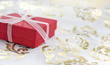 red gift box on golden decorative background