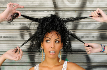 Wall Mural - Young black woman, afro hairstyle, in urban background