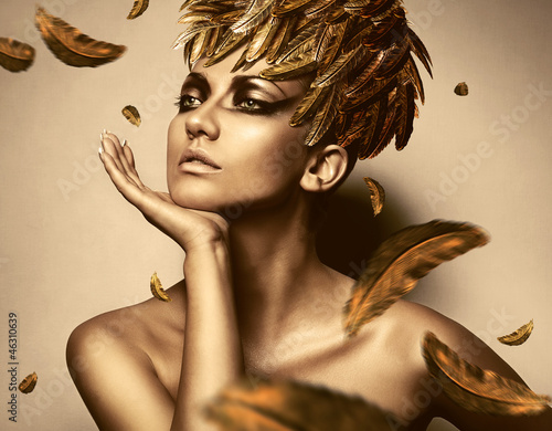 Fototapeta na wymiar sexy woman in feather gold hat