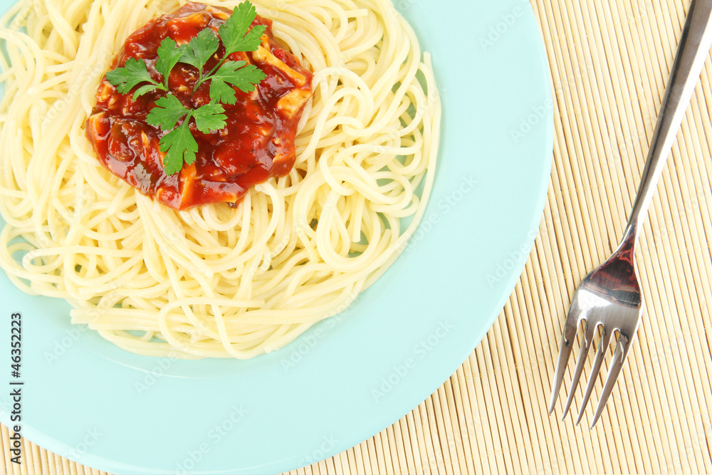 Italian spaghetti in plate on bamboo mat