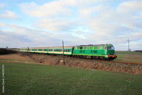Naklejka - mata magnetyczna na lodówkę Passenger train passing through countryside