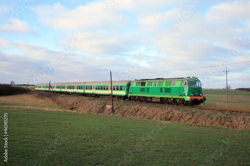 Naklejka ścienna Passenger train passing through countryside