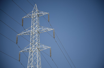 Electricity pylon against blue sky