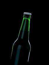 A Green Bottle Beer Over Black Background With Shadow