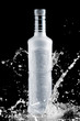 iced bottle of vodka splash on a black background