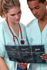 Two doctors examining x-ray image