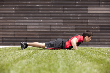 Wall Mural - Athlete man making pushups