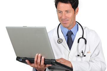 Doctor holding laptop computer