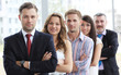 © opolja - Group portrait of a professional business team looking at camera