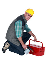 craftsman holding his tool box and welding torch