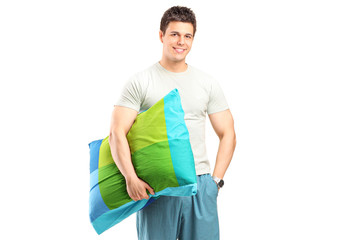 Sticker - A smiling man in pajamas holding a pillow