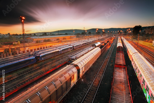 Naklejka dekoracyjna Cargo train platform at sunset with container