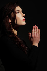 Young caucasian woman praying