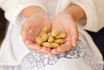 Woman with peanuts in hands