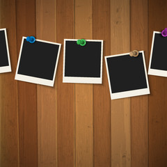 Wall Mural - photo frames with colored pushpins on wooden background