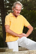 © ysbrandcosijn - Senior man stretching his leg. Doing workout in nature.