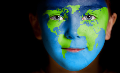 portrait of a child with a painted world map