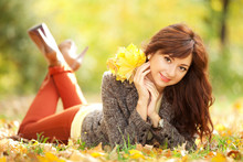 Young Pretty Woman Resting In The Autumn Park