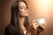© Africa Studio - beautiful young woman with cup of coffee, on brown background