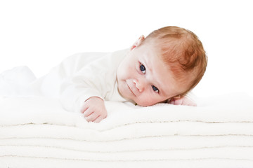 Blue eyes baby boy on white towels