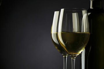 Wall Mural - white wine glass silhouette black background