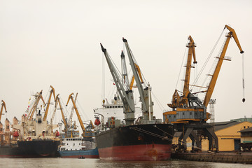  Port or commercial harbor with cargo ship and cranes