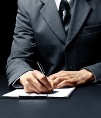 businessman signing a document