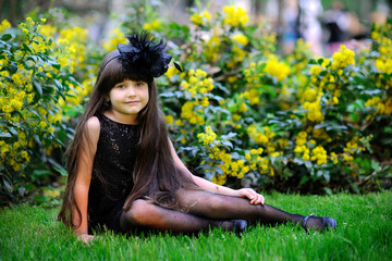 portrait of little girl outdoors in black dress