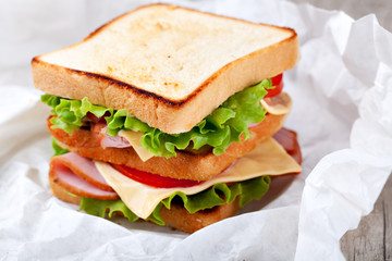 Canvas Print - Sandwich with bacon and vegetables on wooden table