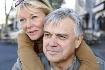 Wall Mural - Portrait of senior man holding woman on his back