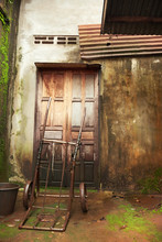 Old Wooden Door And Wall Of A House Damaged By Moisture