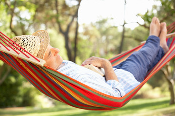 Wall Mural - Senior Man Relaxing In Hammock