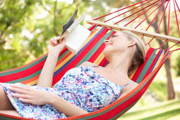 Wall Mural - Woman Relaxing In Hammock With Book