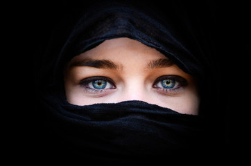 Wall Mural - Portrait of beautiful woman with blue eyes wearing black scarf