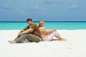 Wall Mural - Young couple on caribbean beach on honeymoon