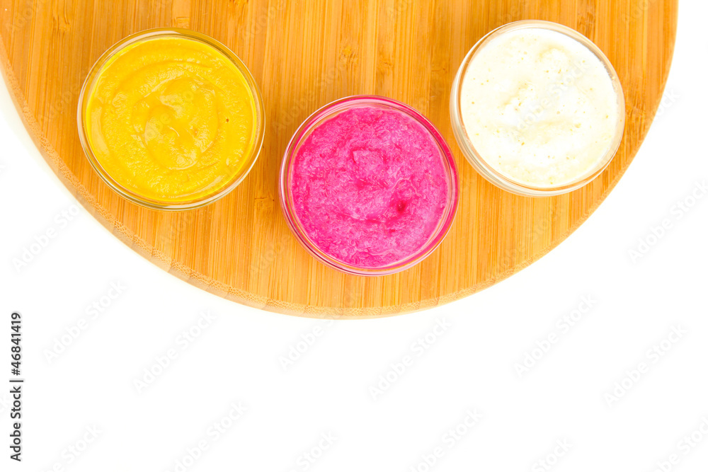 various sauces on chopping board isolated on white