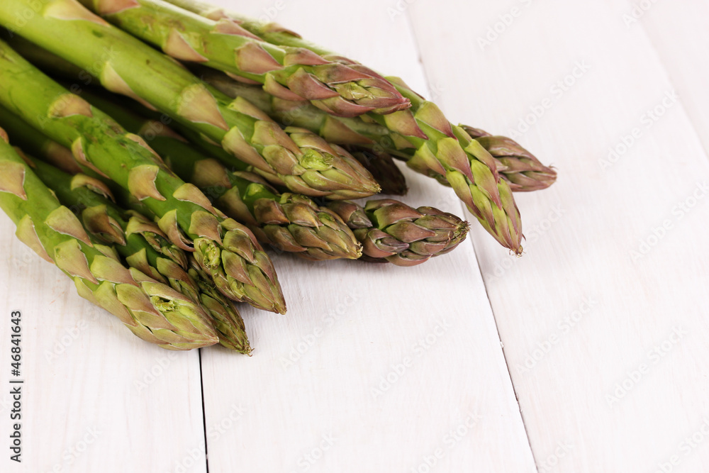 Fresh asparagus on white wooden table background