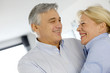© goodluz - Portrait of cheerful senior couple at home