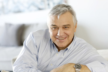 Portrait of senior man relaxing in sofa at home