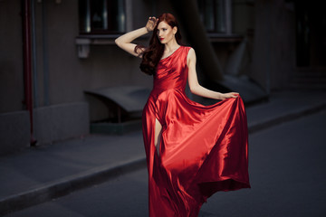 Wall Mural - Young Beauty Famous Woman In Red Dress Outdoor