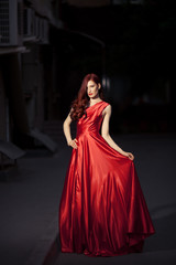 Wall Mural - Young Beauty Famous Woman In Red Dress Outdoor