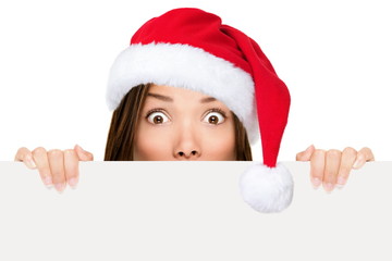 Santa hat woman showing christmas sign