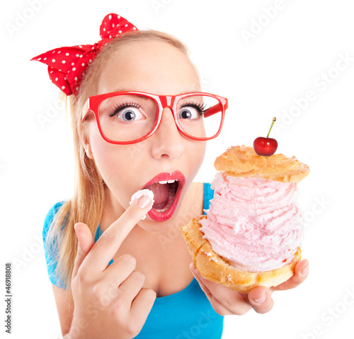 Fototapeta na wymiar Funny girl eating a cream puff