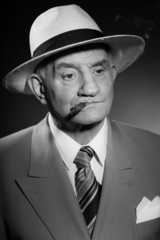 Senior vintage man wearing hat. Black and white shot. Gangster.