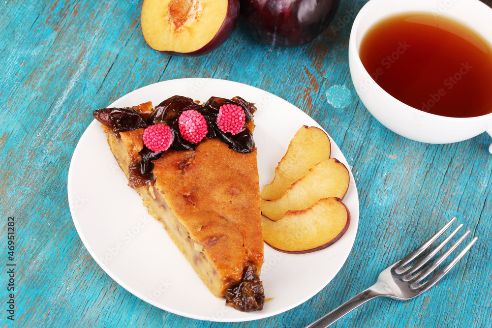 Tasty pie on plate on wooden table