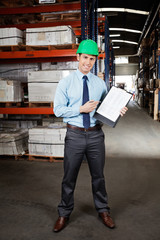 Wall Mural - Confident Supervisor Displaying Clipboard