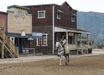 Fototapete - Cowboy Riding his horse at Mini Hollywood, Almeria, Spain