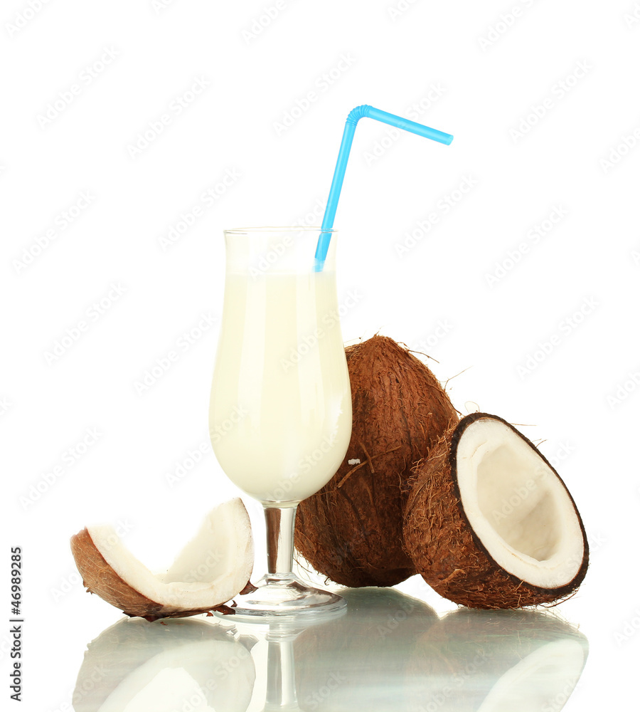 glass of coconut milk and coconuts isolated on white